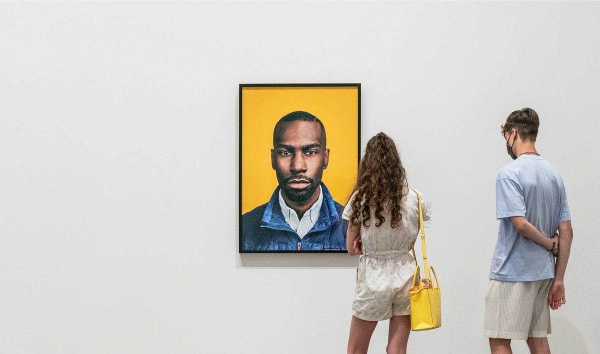 Image of two individuals viewing a portrait in a Gallery